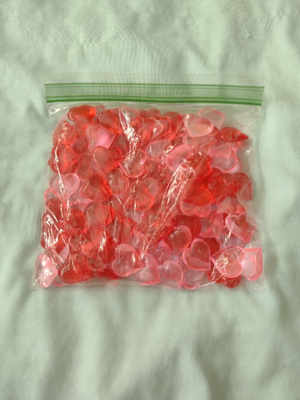 A Bag of Red and Pink Acrylic Heart Gems